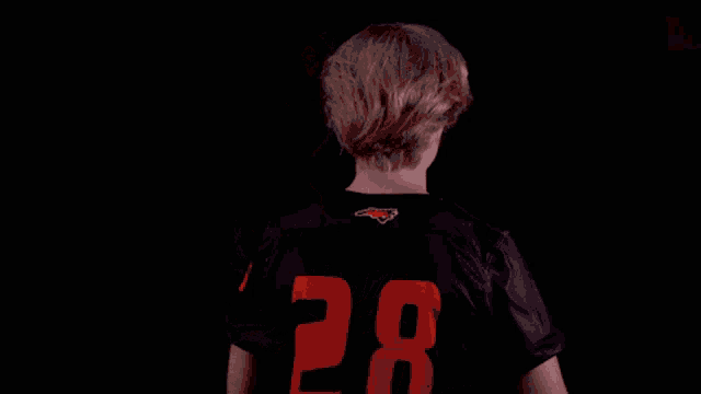 a young man wearing a black shirt that says campbell on it