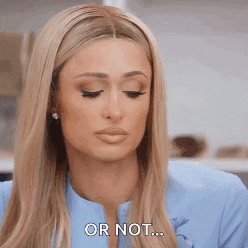 a woman with long blonde hair is wearing a blue jacket and earrings and says or not .
