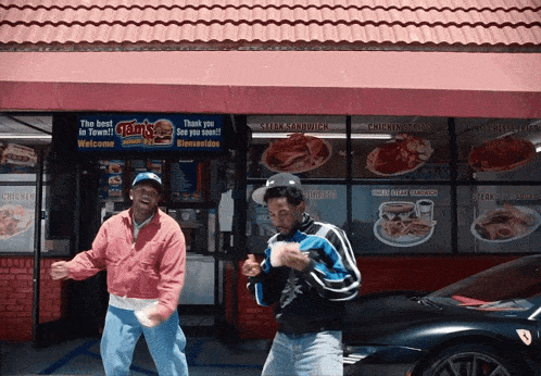 two men standing in front of a fast food restaurant