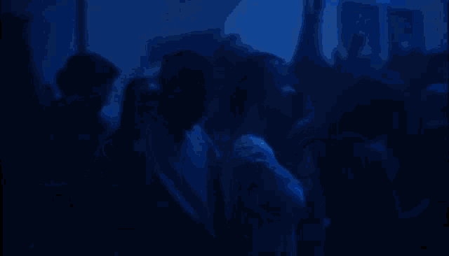 a blurry photo of a person in a dark room