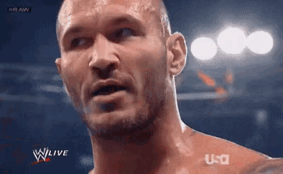 a close up of a wrestler 's face during a wrestling match on tv .