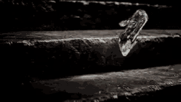 a piece of ice is floating in the air on a rock .