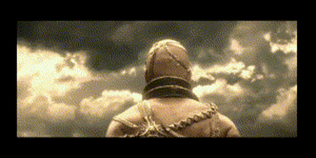 a pixelated image of a man standing in front of clouds