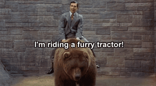 a man in a suit and tie is riding a furry bear