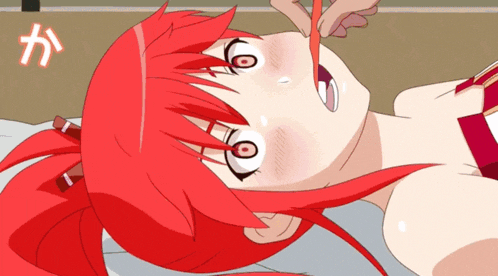 a girl with red hair is laying on a bed with a pencil in her mouth