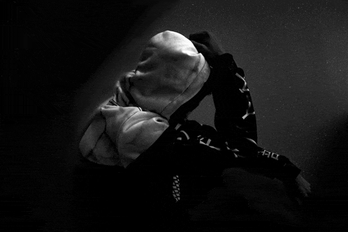 a black and white photo of a person wearing a hoodie with chinese writing on it