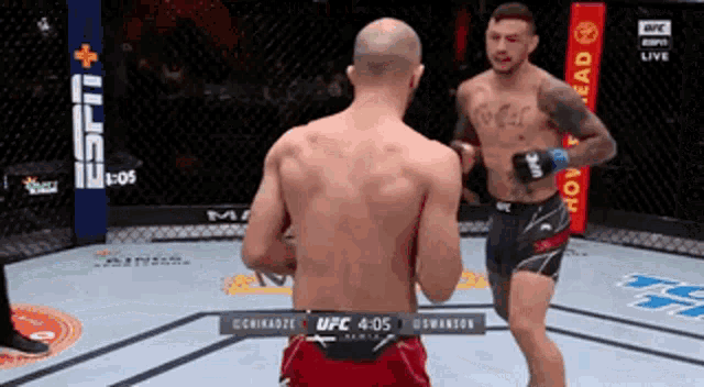 two men are fighting in a boxing ring with a espn logo in the background