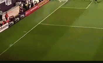 a soccer game is being played in front of a banner that says ' one team '