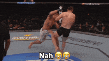 two men are fighting in a boxing ring with the word nah on the bottom