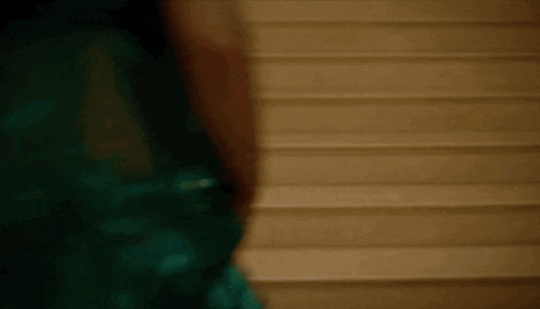 a close up of a person standing on a set of stairs in a dark room .