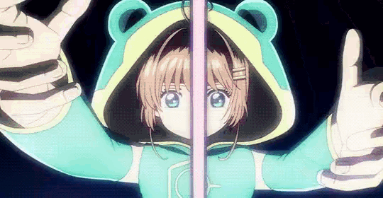 a girl in a teddy bear hoodie is standing next to a glass wall .
