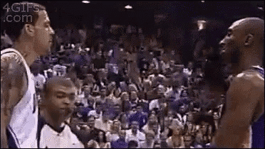 a group of basketball players are standing next to each other on a court .