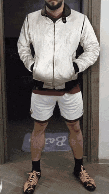 a man wearing shorts and a white jacket stands in front of a door that says bar on it