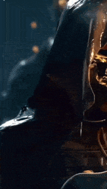 a grim reaper with a hood on has a skull on his face