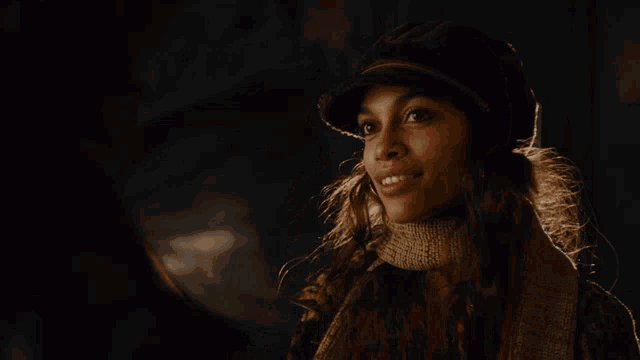 a woman wearing a hat and scarf has the word sure on her face