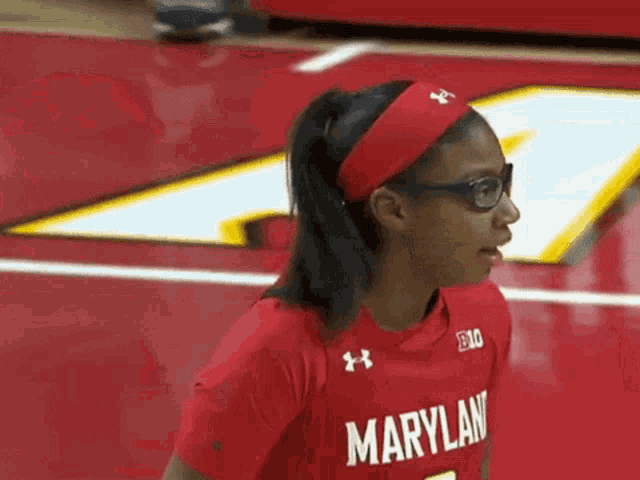 a woman wearing glasses and a red maryland shirt