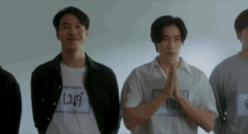 a group of young men are standing next to each other with their hands folded and one of them has a name tag that says lau