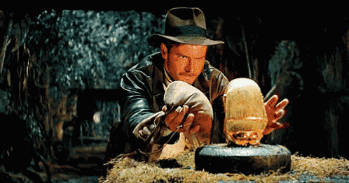 a man in a hat is looking at a statue of a skull