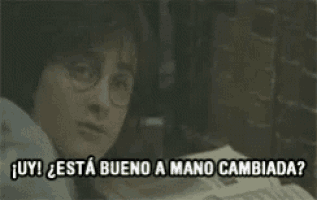 harry potter is talking to someone in spanish while holding a piece of paper .