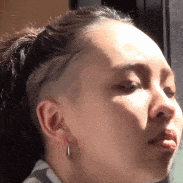 a close up of a woman 's face with earrings