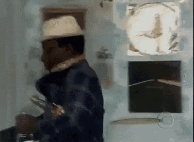 a man in a hat is standing in a room