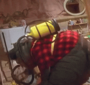 a person wearing a red and black plaid shirt and a yellow gas mask