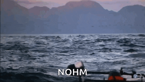 a boat in the ocean with the words " nohm " written on the bottom