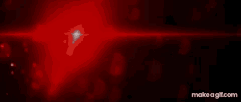 a red light is shining on a black background with hearts flying in the air .