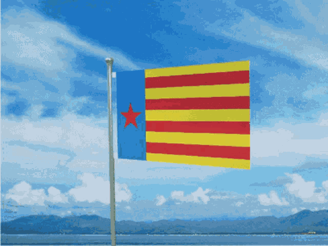 a blue yellow and red flag with a red star