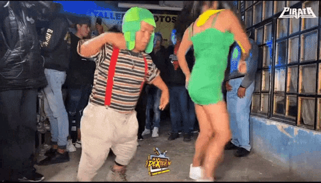 a man in a green hat is dancing in front of a sign that says pirata