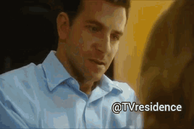 a man in a blue shirt is looking at a woman with the words @tvresidence on the bottom