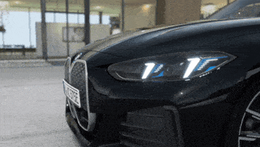 a close up of a black car with a license plate that says ' nc ' on the front