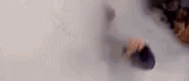 a man with a beard is standing in a foggy room .