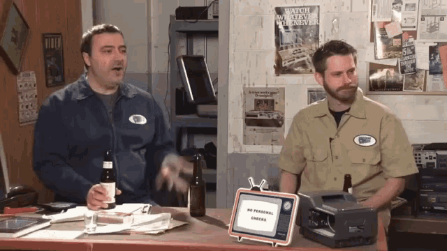 two men sitting at a desk with a sign that says no personal orders