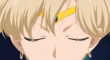 a close up of a blonde anime character with blue eyes and a yellow crown on her forehead