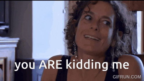 a woman is smiling with the words " you are kidding me " behind her
