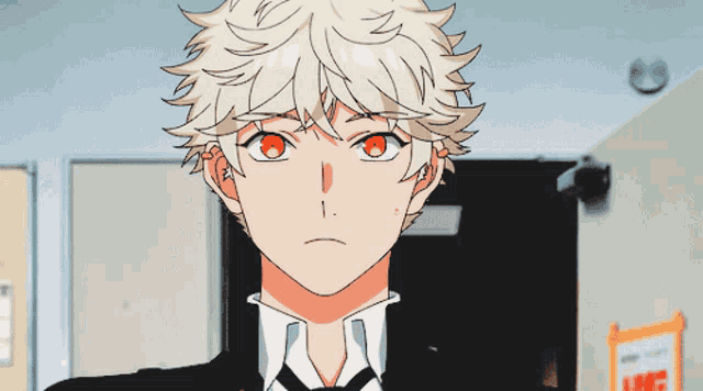 a boy with blonde hair and red eyes looks at the camera