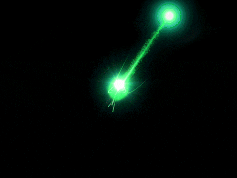 a green light beam is shining on a dark background