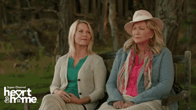two women sit on a bench with the words heart & home on the bottom right