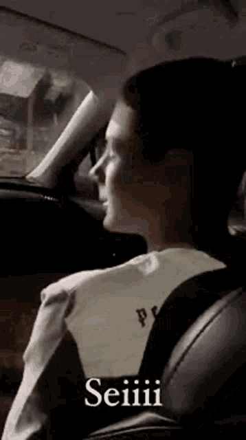 a man is sitting in the back seat of a car .