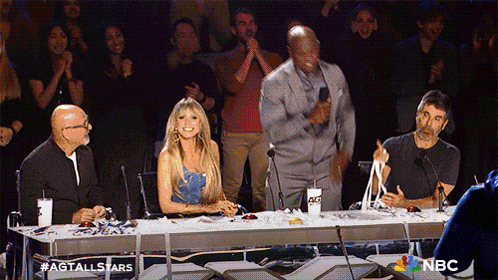 a group of people sitting at a table with a nbc logo on the bottom