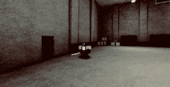 a black and white photo of a dark room with a light on the floor