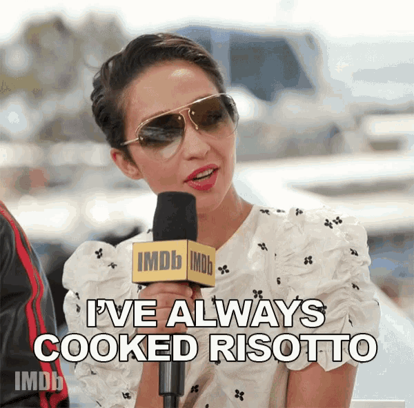 a woman wearing sunglasses is talking into an imdb microphone and says " i 've always cooked risotto "