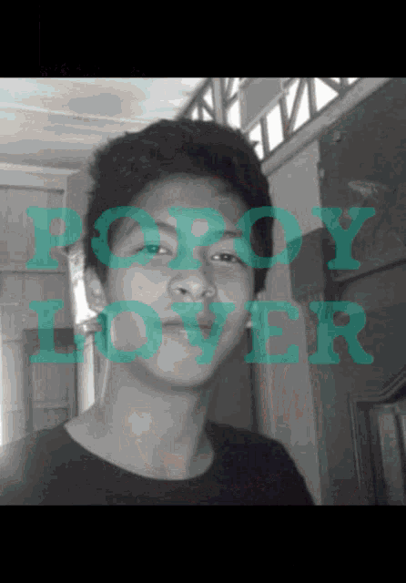a black and white photo of a young man with the words " poroy lover " on the bottom right