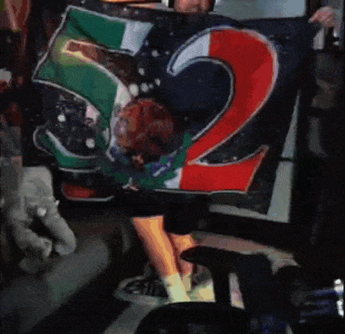 a person is holding a flag that has the number 52 on it
