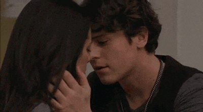 a man and a woman are kissing each other .