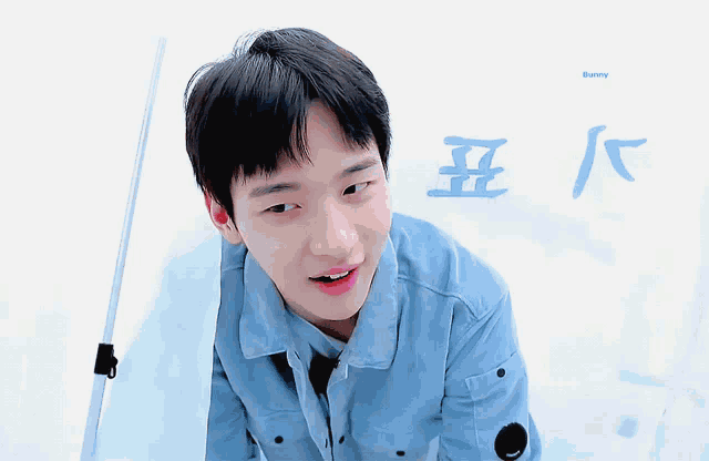 a boy in a blue jacket is looking at the camera with bunny written on the bottom of the image