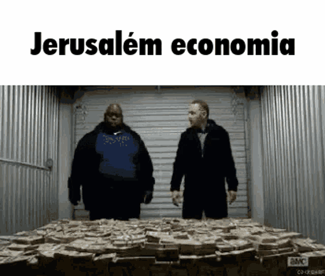 two men are standing next to a pile of money in a garage .