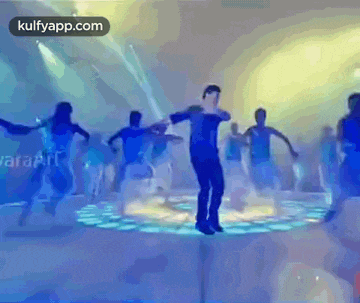 a group of people are dancing on a stage with the website kulfyapp.com visible in the corner