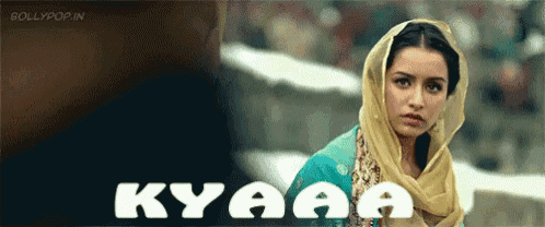a woman is wearing a scarf around her head and the word kyaaa is on the bottom
